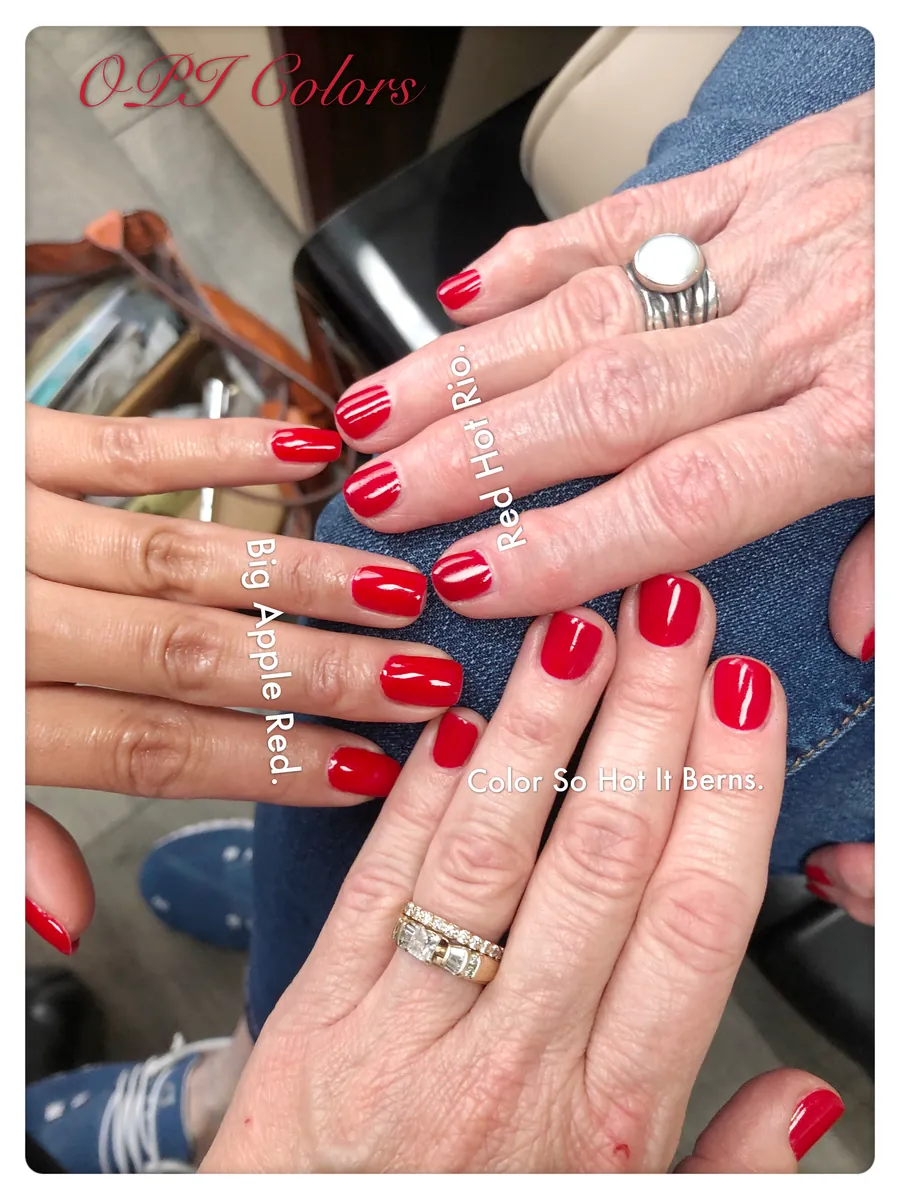 Glossy OPI red gel manicures on several happy clients at Ultimate Beauty Salon