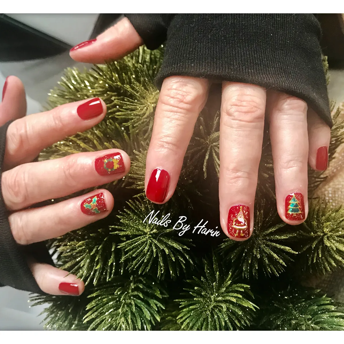 Festive red manicure with hand-painted holiday nail art by Harin
