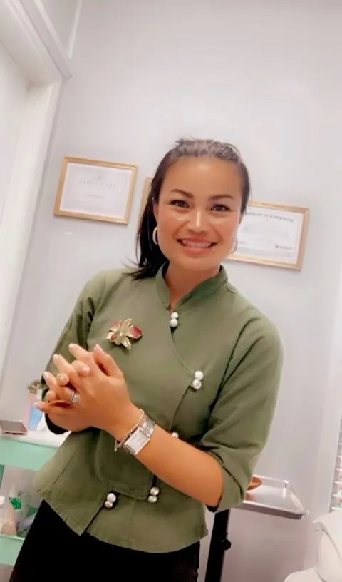Harin smiling in her nail studio at Ultimate Beauty Salon
